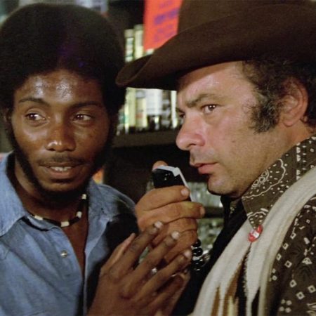 Franklyn Ajaye and Burt Young in Convoy (1978)