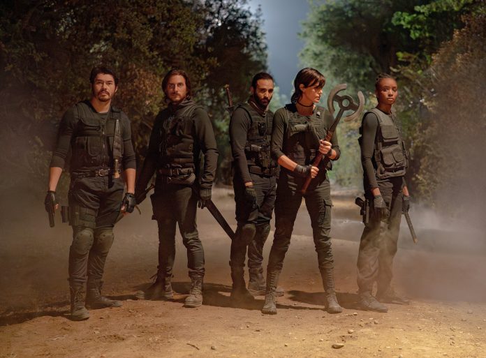 The Old Guard 2 (L-R) Henry Golding as Tuah, Luca Marinelli as Nicky, Marwan Kenzari as Joe, Charlize Theron as Andy and KiKi Layne as Nile in The Old Guard 2. Cr. Eli Joshua Ade/Netflix © 2025