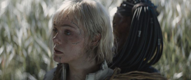 Dimitrius Schuster-Koloamatangi and Elle Fanning in Predator: Badlands (2025)